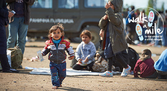 young refugee child walking in a refugee camp