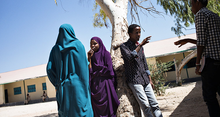 Students spend time in the grounds of the new school